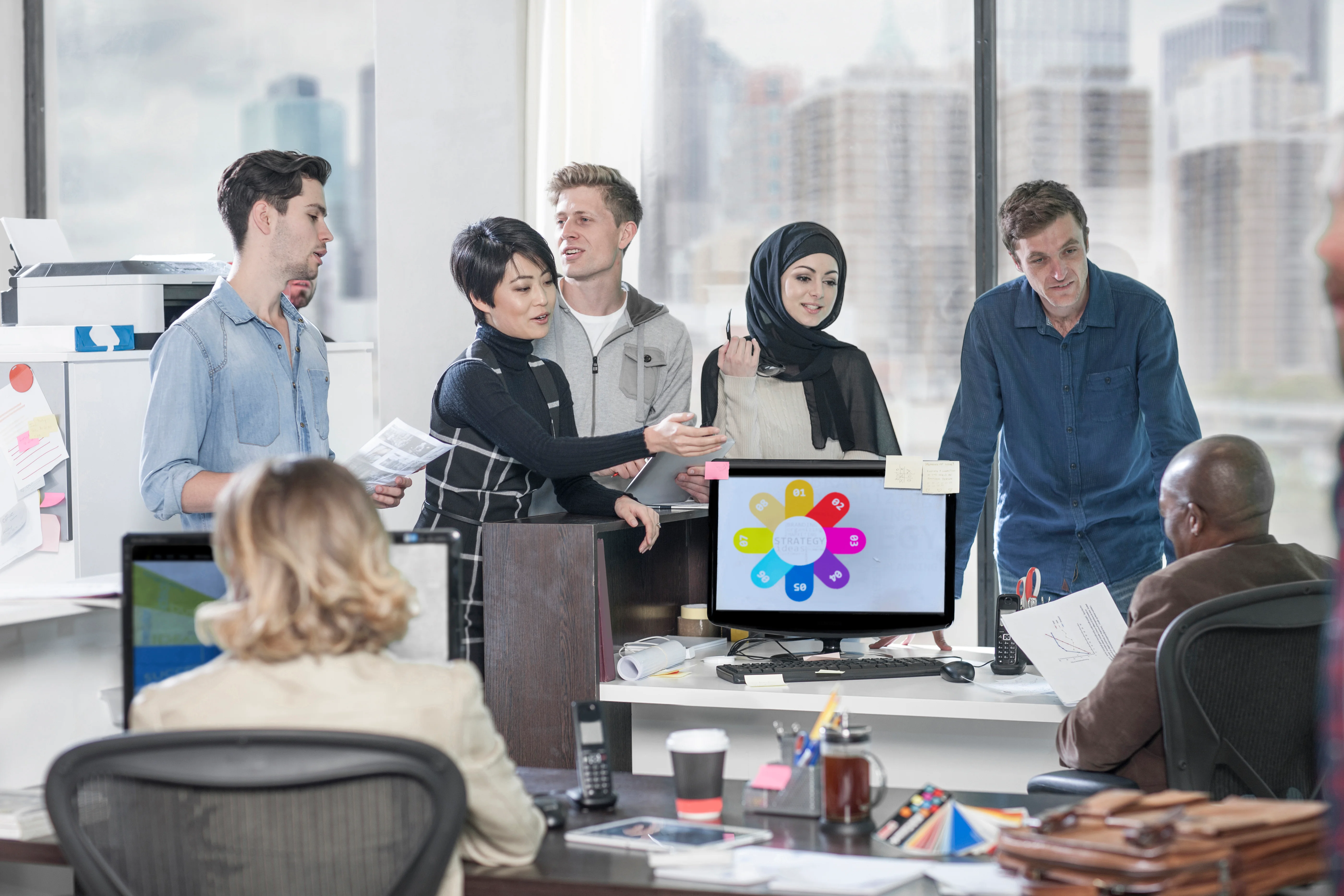A group of coworkers discussing some changes to operations.