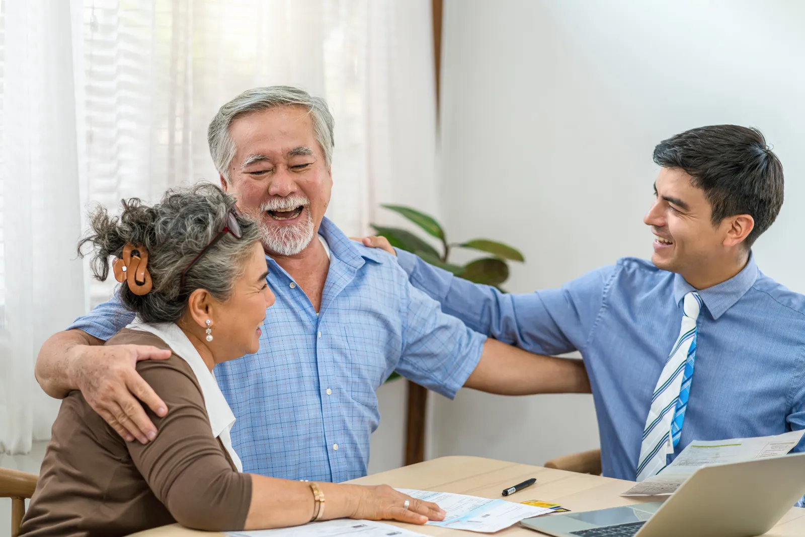 A senior couple excited about their new life insurance policy.
