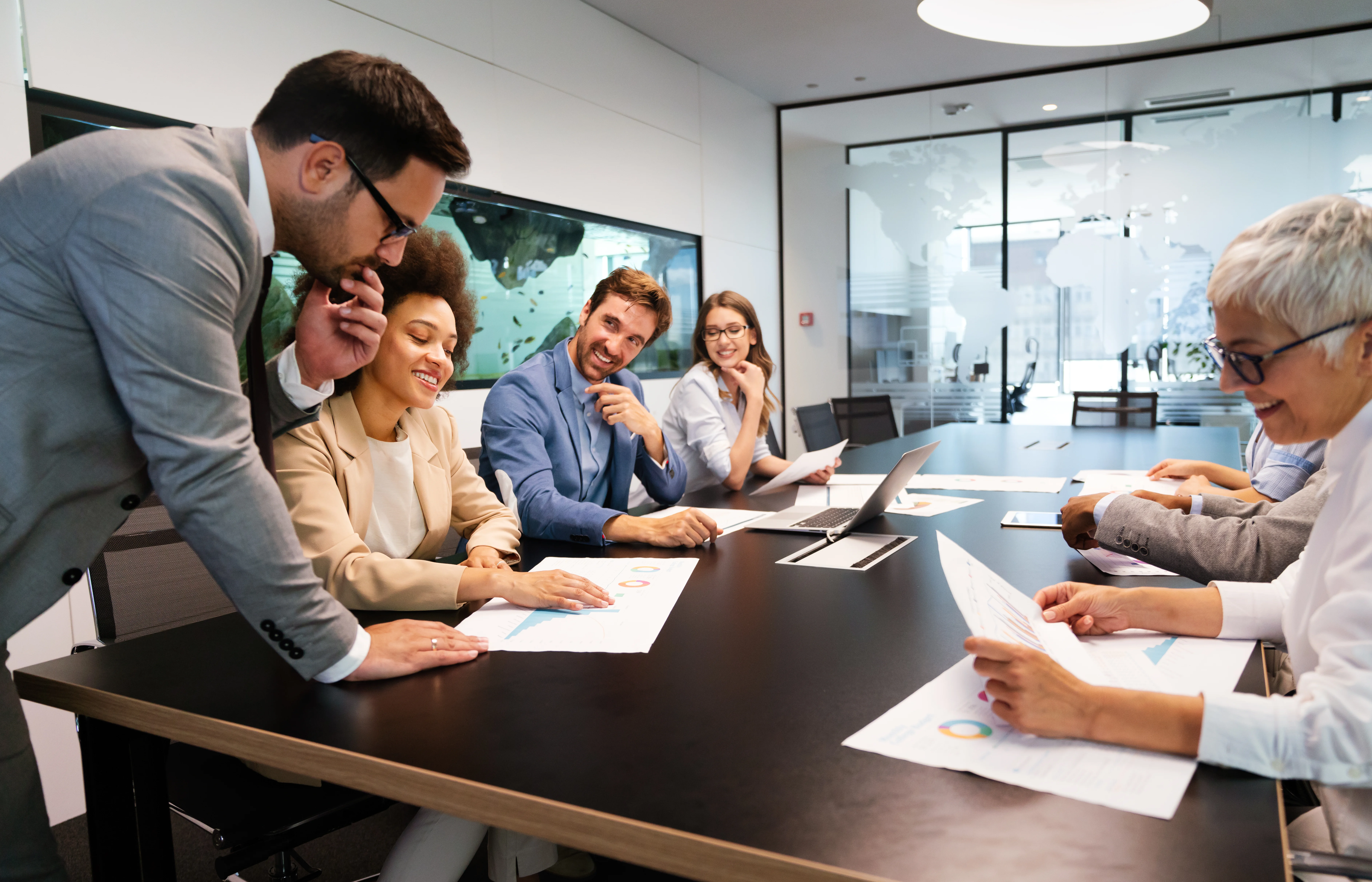 A group of people in a conference room deciding on something.